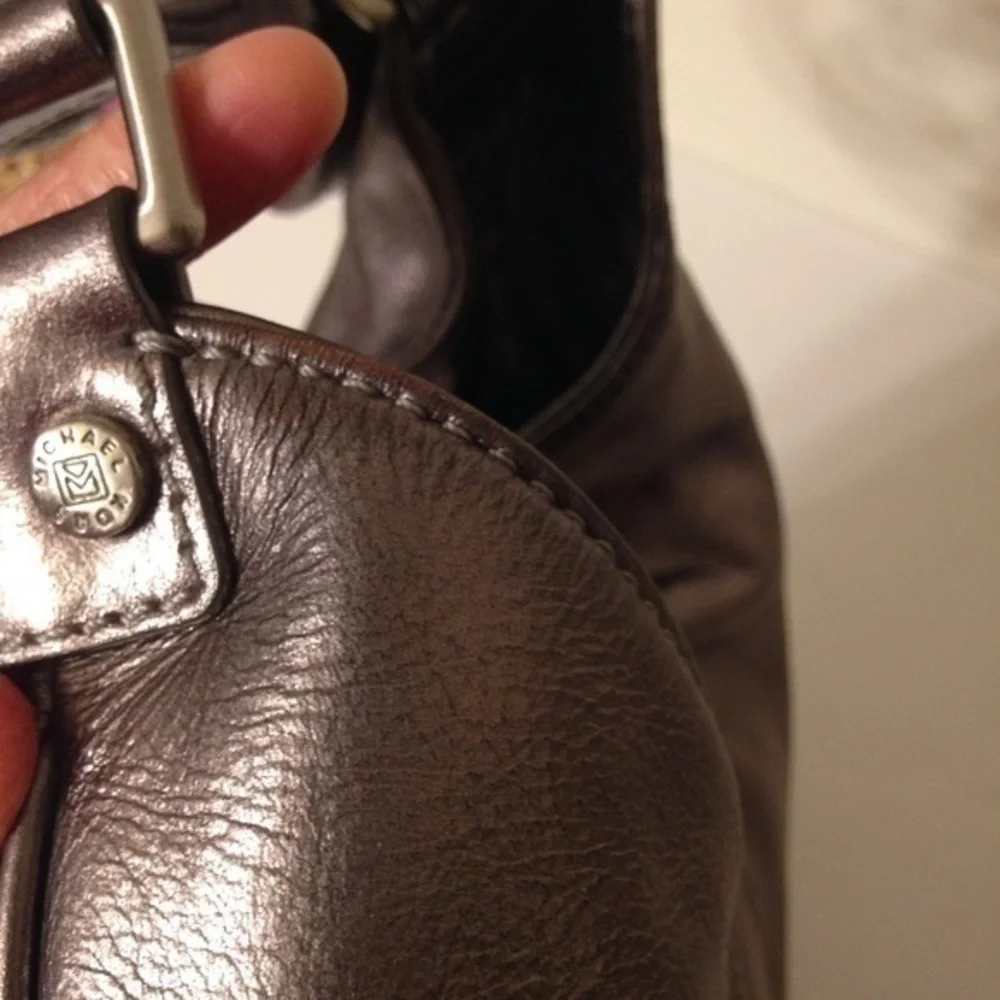 Michael Kors silver metallic hobo bag buckle
